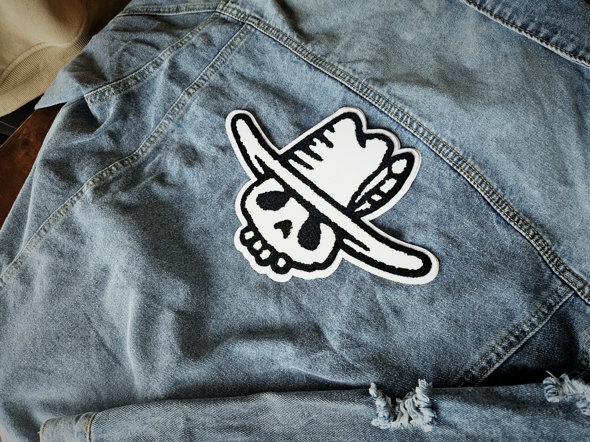 Chenille skull patch on the back of a denim jacket