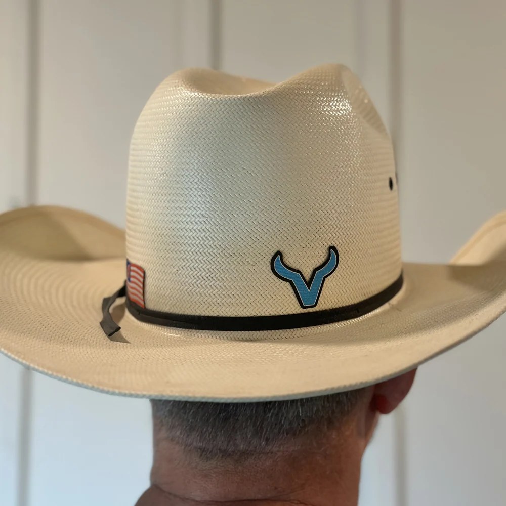 Straw cowboy hat with a custom patch on the crown